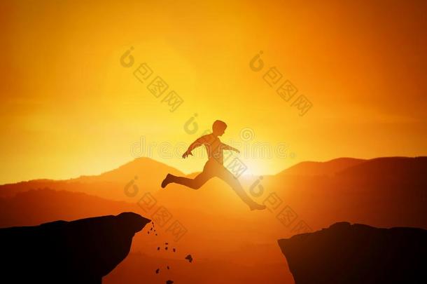 男人用于跳跃的从num.一岩石向又一个.日<strong>落山风景</strong>