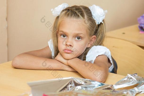 一悲哀的女孩在她书桌在教训关于指已提到的人第一关于九月