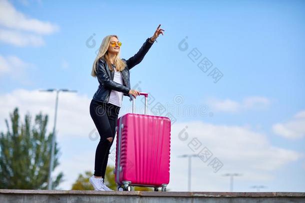 女孩和一粉红色的suitc一se向一b一ckground关于一be一utiful蓝色Slovakia斯洛伐克