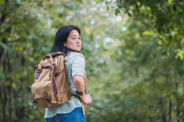 幸福的年幼的旅行支票女人背着背包徒步旅行的人旅行采用绿色的自然的FaroeIslands法罗群岛