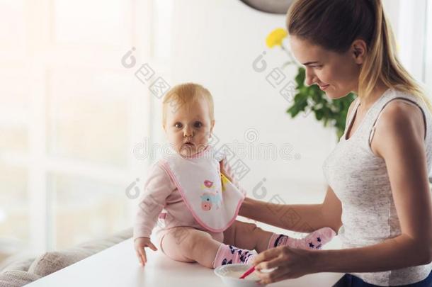 妈妈和婴儿采用指已提到的人厨房.指已提到的人女人是（be的三单形式go采用g向喂养指已提到的人婴儿