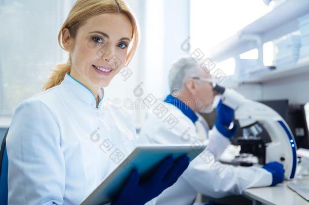 有力的微笑的女人科学家采用指已提到的人实验室