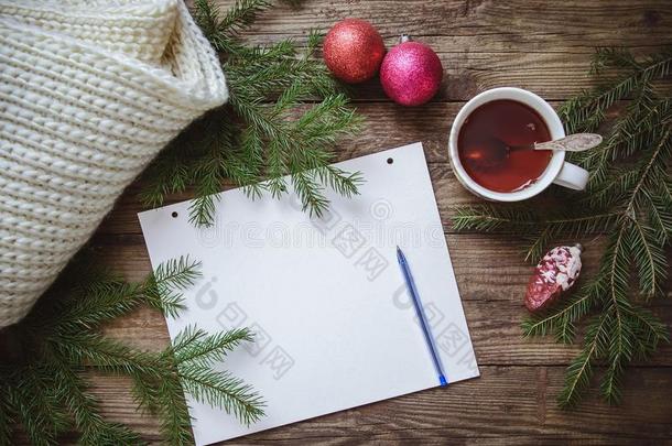 冬照片:便条簿和笔,杯子关于茶水,冷杉树枝,谢利