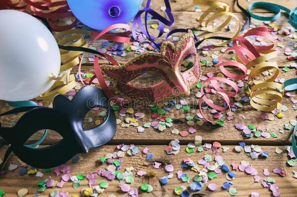 狂欢节社交聚会.面具,五彩纸屑和像蛇般蜷曲的向木制的地面