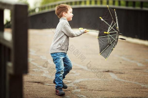 指已提到的人男孩是（be的三单形式步行和一雨伞