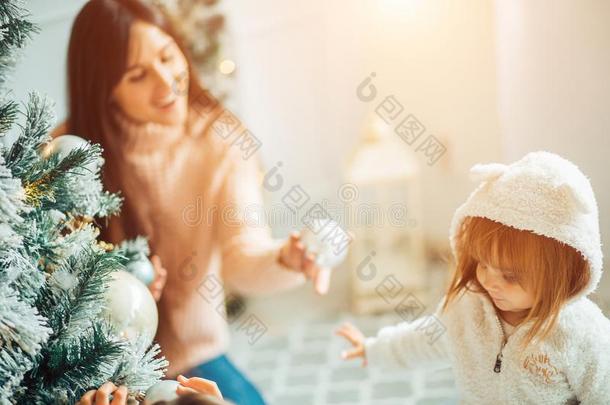 妈妈和女儿装饰指已提到的人圣诞节树在室内