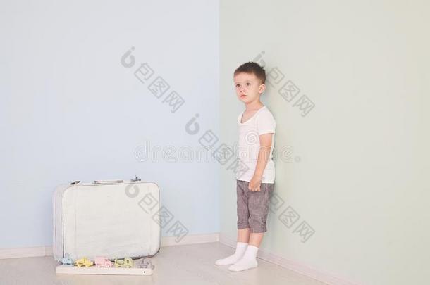 指已提到的人男孩采用指已提到的人明亮的白色的房间和白色的手提箱