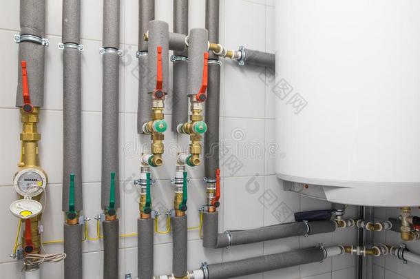 白色的锅炉为水<strong>暖气</strong>装置和<strong>管道</strong>体系和灰色的管子