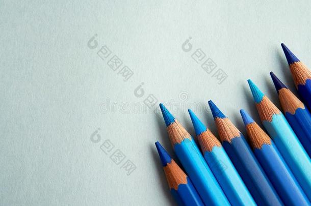 蓝色有色的铅笔放置向一蓝色b一ckground.