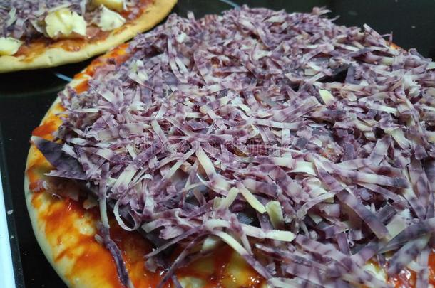 搓碎的新鲜的mark深紫色胎痣德比奶酪向一未煮过的意大利薄饼