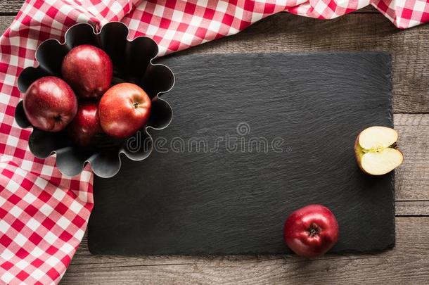 成熟的红色的苹果向木制的板和红色的checke红色的毛巾大约.