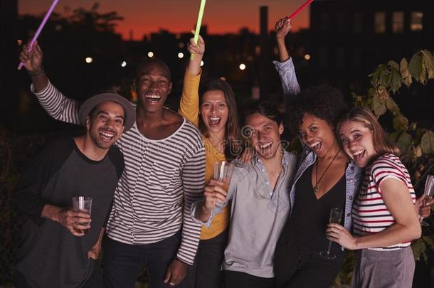 幸福的朋友波浪状的发光棒在屋顶社交聚会采用反击球