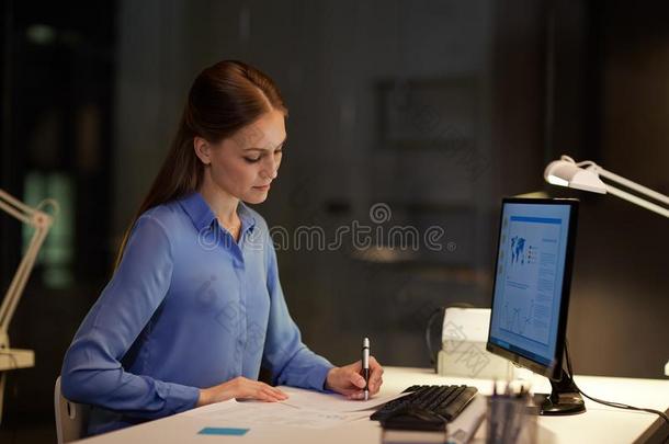 女商人在计算机<strong>工作</strong>的在夜办公室