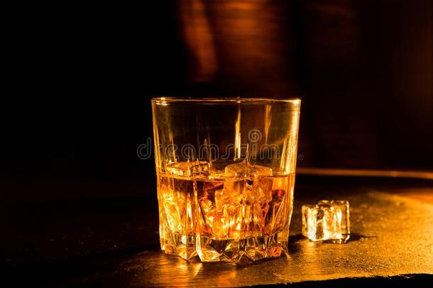 <strong>威士忌</strong>酒喝向木制的表越过黑暗的背景