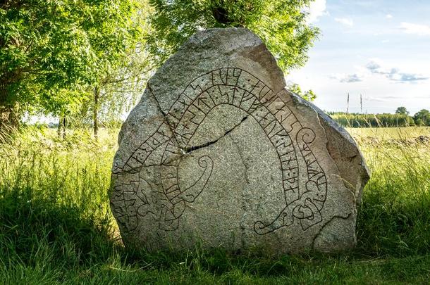 古代的和有裂缝的古代北欧文字石头和夏背景