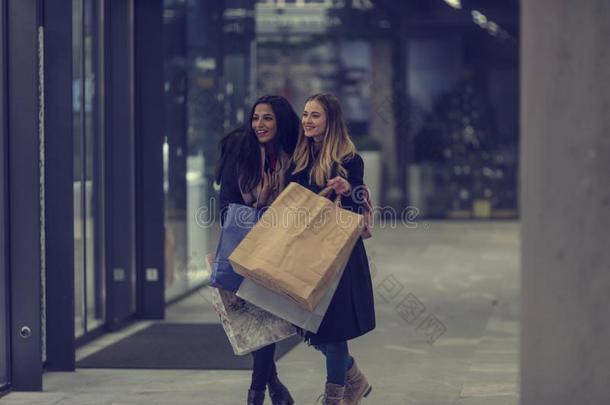 两个漂亮的青少年年幼的女人购物向一寒冷的冬埃文