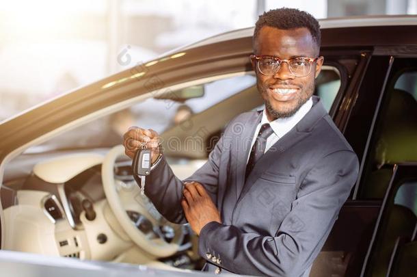 年幼的非洲的商人一次采用一汽车展映汽车钥匙