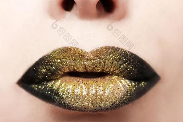 嘴唇化妆从金色的和黑的口红