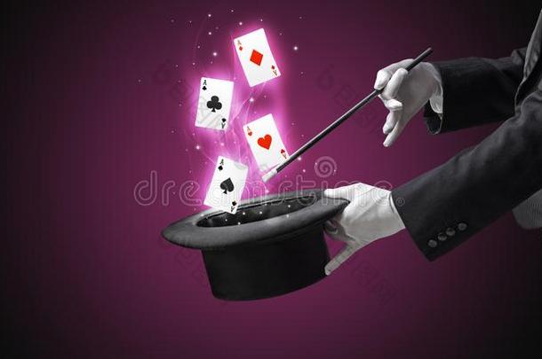魔术师制造戏法和魔杖和演奏卡