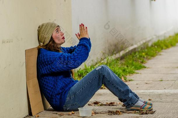 户外的看法关于无家可归的微笑的女人乞讨向指已提到的人大街采用