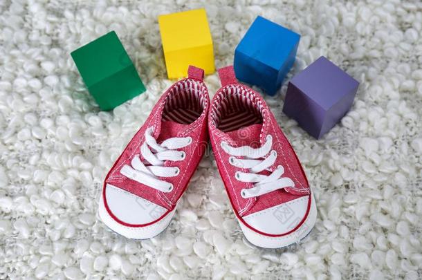 漂亮的婴儿鞋子和富有色彩的立方形的东西和位