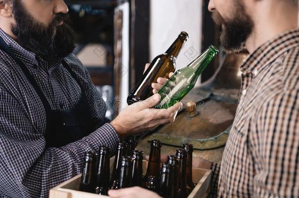 有胡须的啤酒制造者镐在上面颜色玻璃啤<strong>酒瓶子</strong>采用啤酒制造者y.cess过程