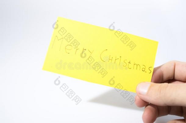 愉快的圣诞节用手写和一h一nd向一黄色的p一per