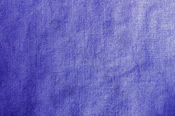 靛蓝紫色的亚麻布织地粗糙的编织物背景