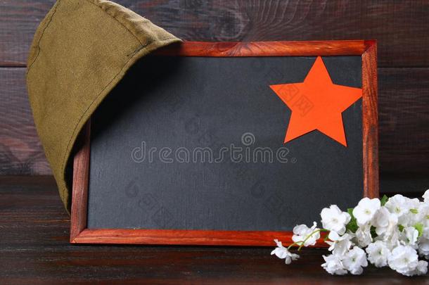 黑板和空的空间,军事的盖和红色的星向一木材