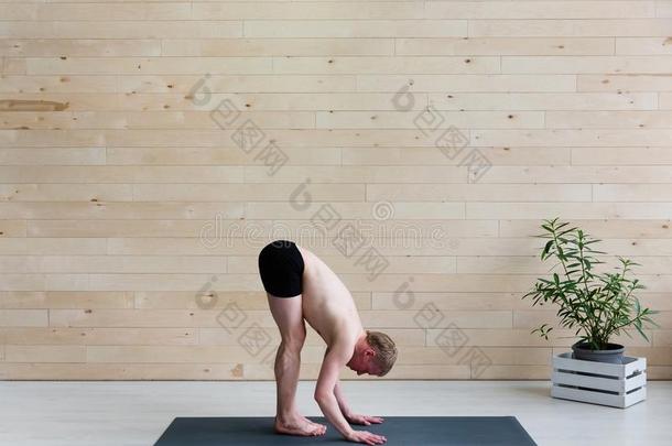 像运动家的男人练习瑜伽倒立瑜珈的任何一种姿势阿多穆卡Vriksh瑜珈的任何一种姿势