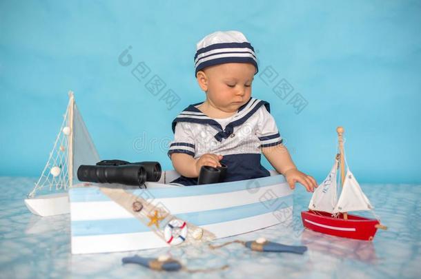 漂亮的蹒跚行走的人婴儿男孩采用木制的小船,play采用g和鱼,斯塔夫