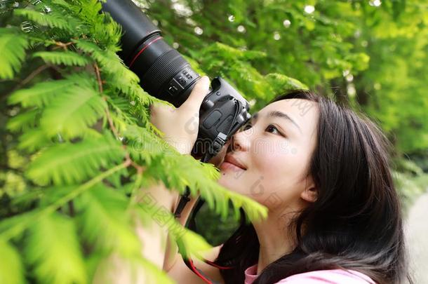 艾桑中国人女人摄影师拿住照相机关向她面容wickets三柱门
