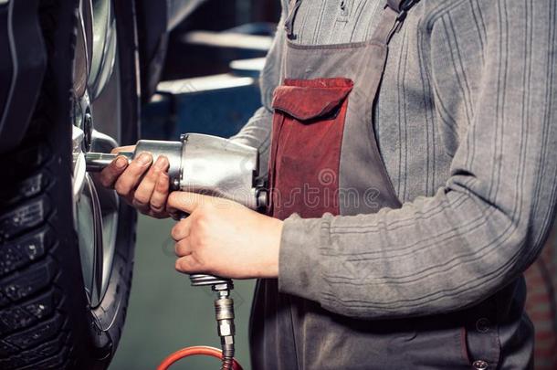 技工用螺丝拧紧或un用螺丝拧紧汽车轮子在旁边充气的扳手