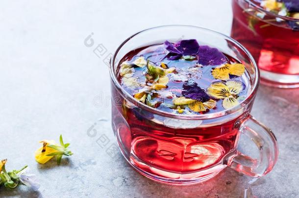 红色的药草的茶水和可以吃的花.