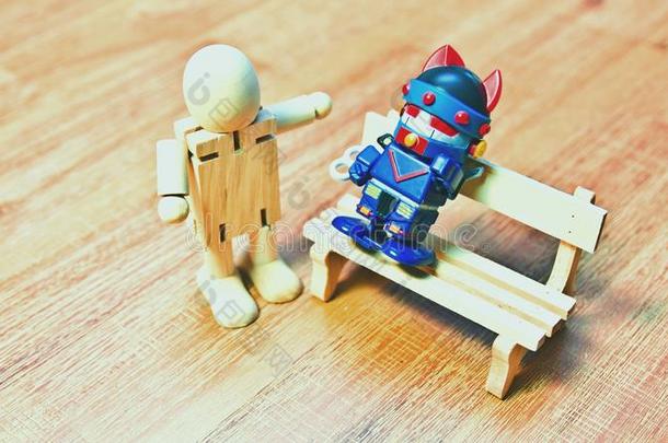 一木制的木偶det.那个使摆姿势一thre一t向一机器人一次向一长凳.
