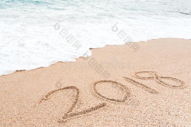 幸福的新的年2018观念.数字2018书面的向沙的海滩