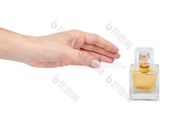金色的香水瓶子和手隔离的向白色的背景