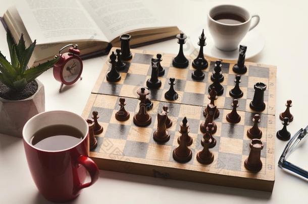 木制的书桌和棋比赛,书和咖啡豆杯子