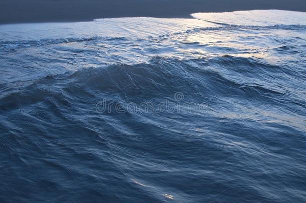 黑暗的蓝色海波浪和海起泡沫关-在上面