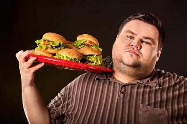 肥的男人吃快的食物汉伯格.Break快的为超重的由