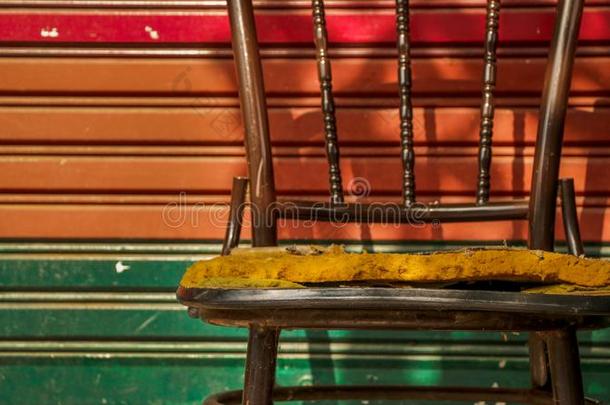 被放弃的酿酒的金属椅子和富有色彩的滚筒遮光器门/