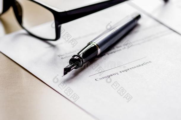 办公室书桌和签署合同,眼镜和笔为商业