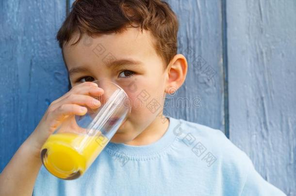 小孩小孩小的男孩喝饮料桔子果汁喝户外的户外的