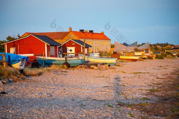 捕鱼小船和捕鱼向指已提到的人海滩在日落光采用瑞典