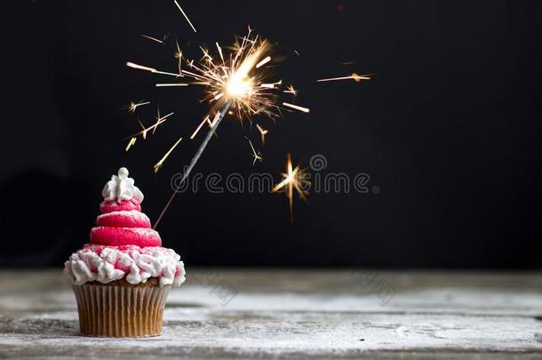纸杯蛋糕和红色的旋转霜状白糖和闪烁发光物,圣诞节纸杯蛋糕