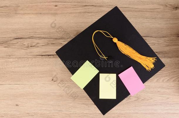 黑的毕业了的盖和黄色的穗向木制的表,富有色彩的英语字母表的第16个字母