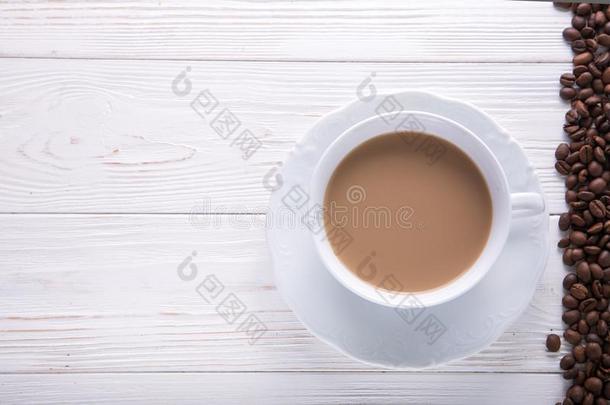白色的杯子关于c关于fee和奶或茶水和奶向白色的木制的英语字母表的第2个字母