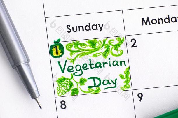 令人回忆起的东西素食者一天采用日历和绿色的笔.