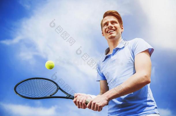 幸福的网球演员准备好的向打球和球拍