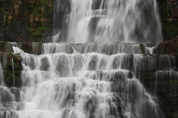 瀑布影像和水流注越过水平关于岩石
